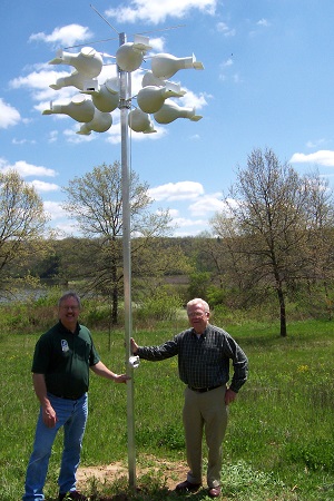 CarolPark Superintendent, Greg Pittz, and John McDaniel with the twelve gourd setup for Purple Martins at Yellowstone Lake State Park.